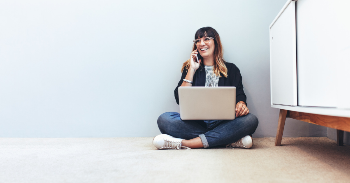 woman on laptop talking on phone