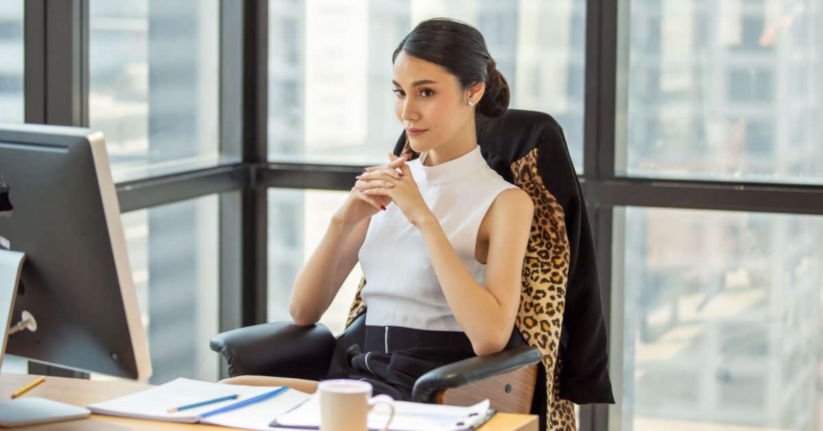 woman seriously thinking at desk