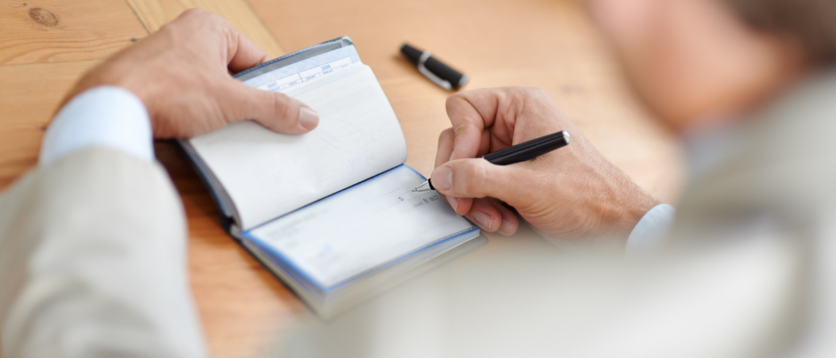 man writing check